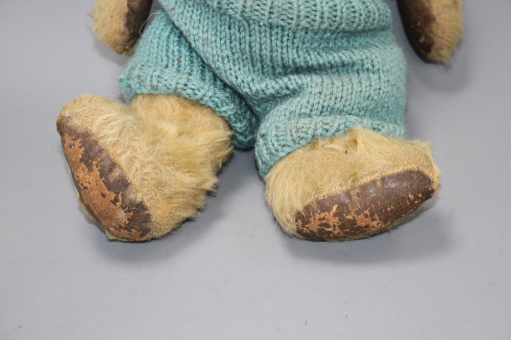 An Omega bear c.1950s, 16in., rexine pads, general hair loss